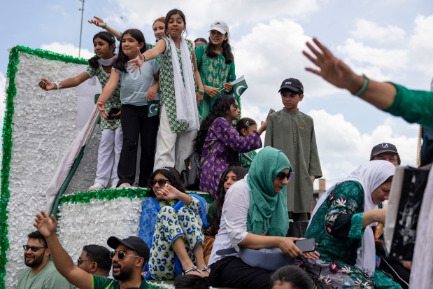 Participants ride a float down West Devon Avenue to celebrate Pakistan Independence Day on Aug. 10, 2025, in the West Rogers Park neighborhood of Chicago. (Brian Cassella/Chicago Tribune)