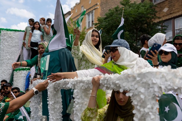 Participants ride a float down West Devon Avenue to celebrate Pakistan Independence Day on Aug. 10, 2025, in the West Rogers Park neighborhood of Chicago. (Brian Cassella/Chicago Tribune)