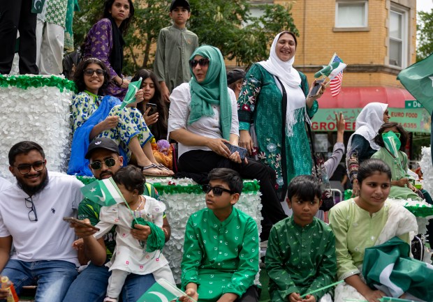 Participants ride a float down West Devon Avenue to celebrate Pakistan Independence Day on Aug. 10, 2025, in the West Rogers Park neighborhood of Chicago. (Brian Cassella/Chicago Tribune)