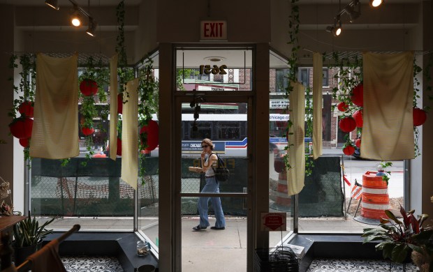 A person walks past Logan Square's Fleur flower boutique at 2651 N. Milwaukee Ave., Aug. 8, 2025. (John J. Kim/Chicago Tribune)