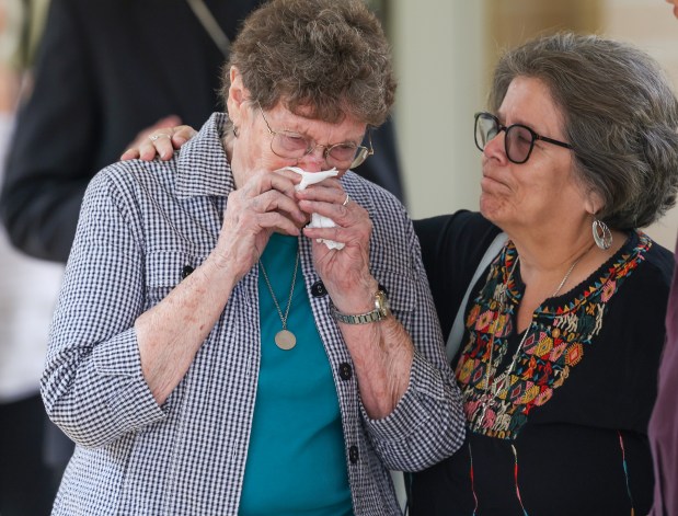 Sister JoAnn Persch, left, is comforted by Marilu Gonzalez at the celebration of life mass for their friend, Sister Pat Murphy, at Mercy Chapel in Evergreen Park on July 31, 2025. (Stacey Wescott/Chicago Tribune)
