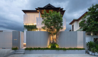 curved textile facades wrap reborn house in bangkok village