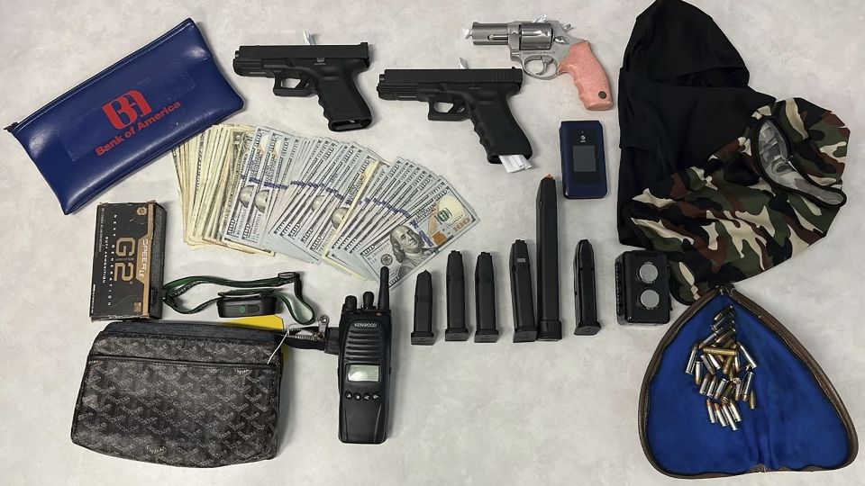 Firearms, cash and stolen valuables were recovered from an operation led by the Los Angeles Police Department on August 20. Police arrested members of a burglary crew suspected of nearly 100 break-ins in the Los Angeles area. - LAPD/AP