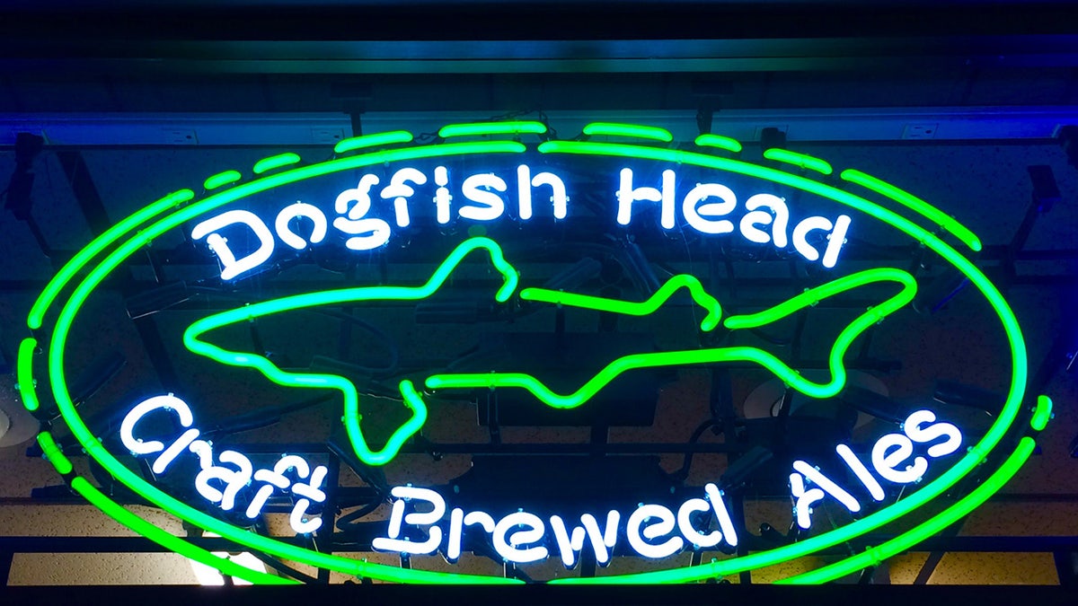 Neon Dogfish Head logo sign seen lit up in Delware