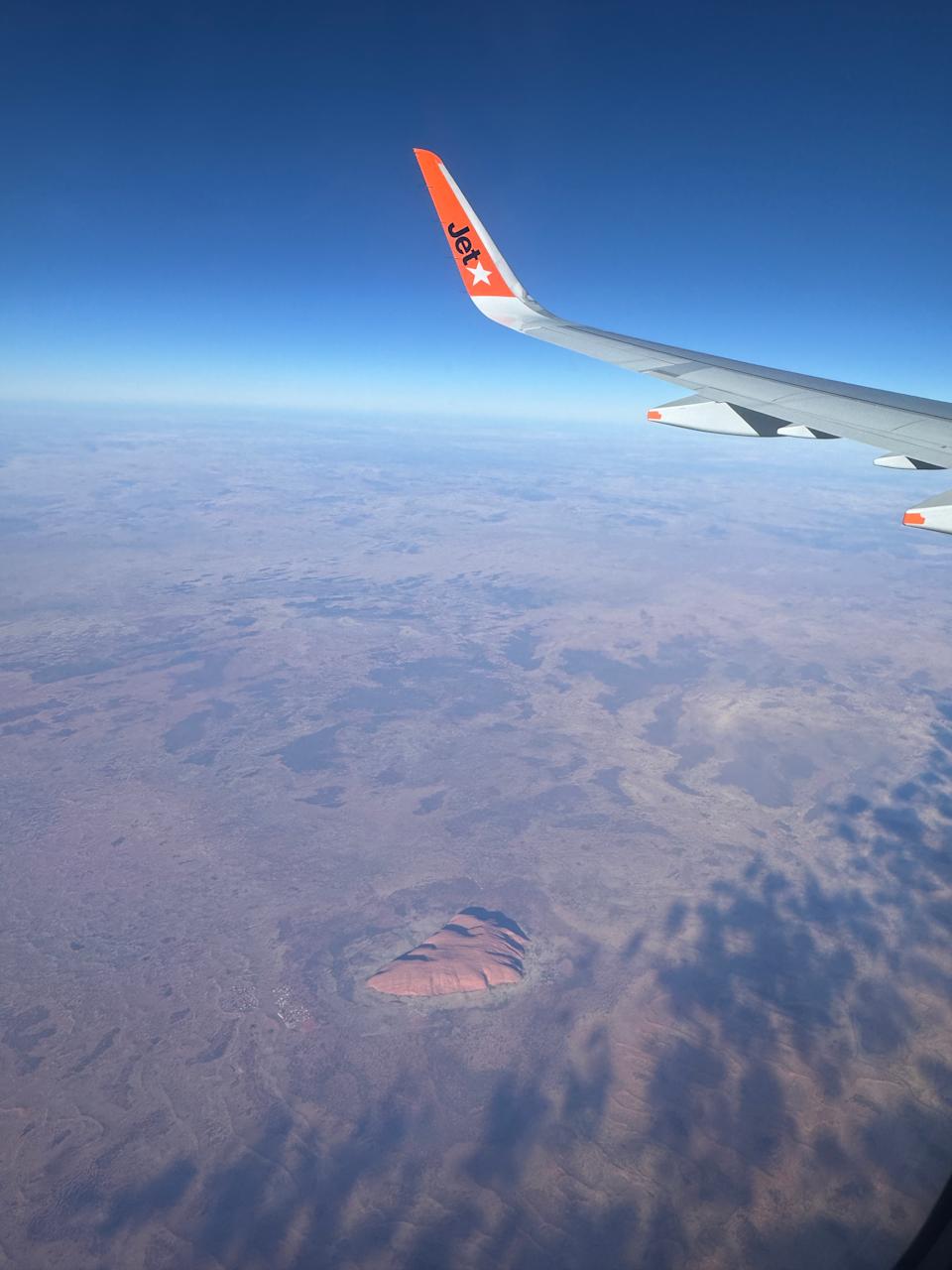 Uluru is pictured from a Sydney woman's seat on board a Jetstar flight. 