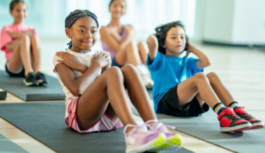 kids doing sit-ups on workout mats