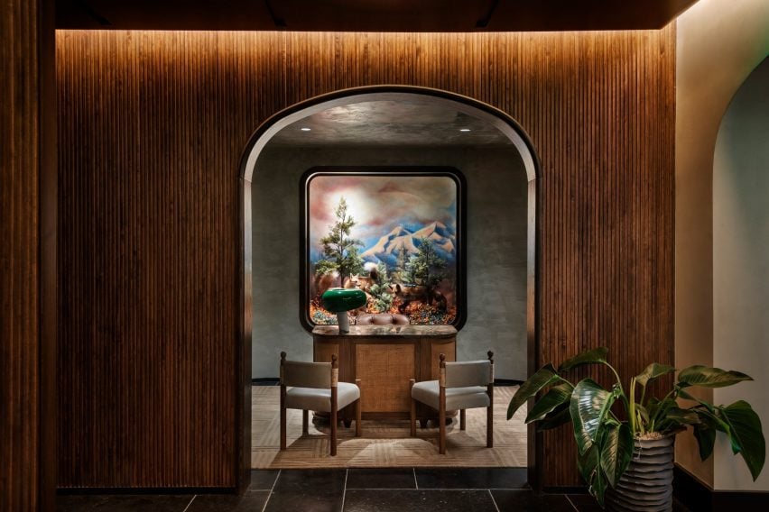 A diorama with taxidermy foxes behind a concierge desk