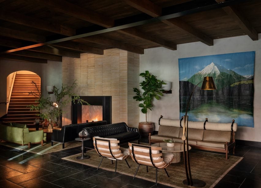Cosy hotel lobby featuring slate floors and a large tile-clad fireplace