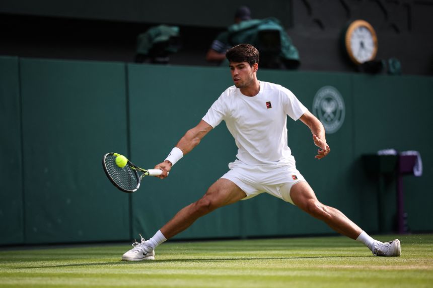 Alcaraz plays a forehand return to Sinner during the Wimbledon final in July.