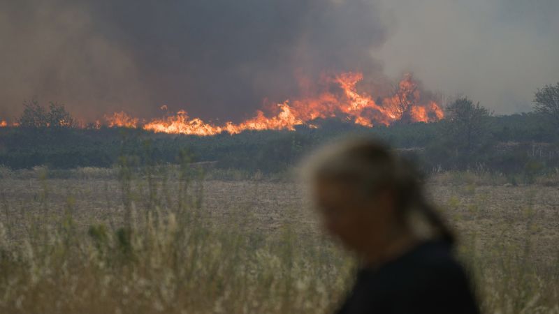 French firefighters battle to contain blaze that killed elderly woman and tore through area bigger than Paris