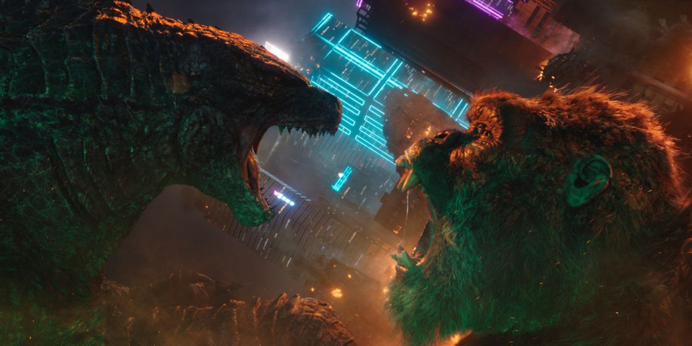 Godzilla and Kong roaring at each other in front of buildings in Hong Kong in Godzilla vs. Kong.