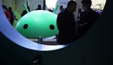 Attendees visit the Google booth where a model of the Android logo is on display at CES 2023 at the Las Vegas Convention Center.