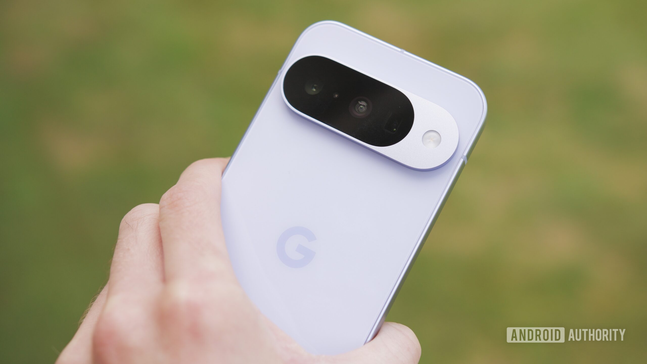 Someone holding the Google Pixel 10, showing the back of the phone.