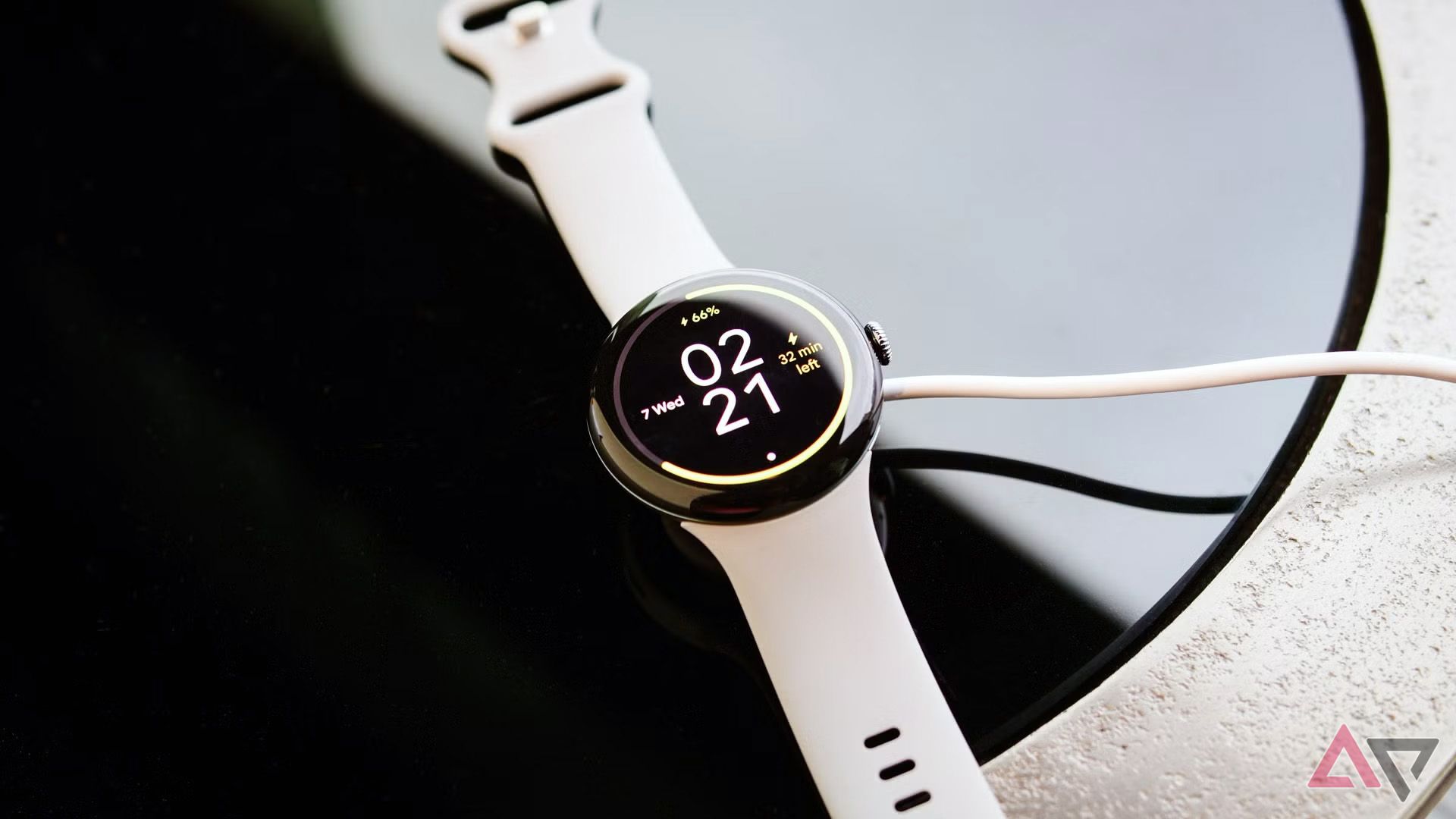 Pixel Watch 3 laying flat on a surface while charging
