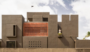 studio nirbaadh's H-house is a composition of layered walls and brick screens
