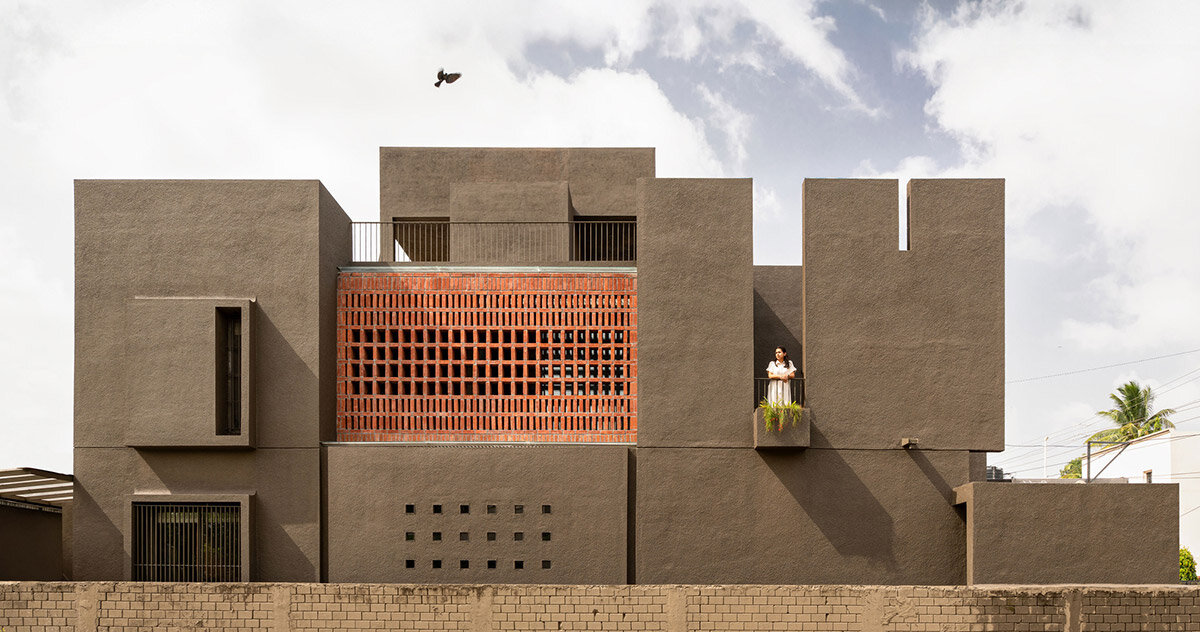 studio nirbaadh's H-house is a composition of layered walls and brick screens