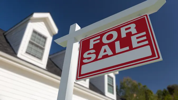 For Sale Real Estate Sign in Front of New House. stock photo