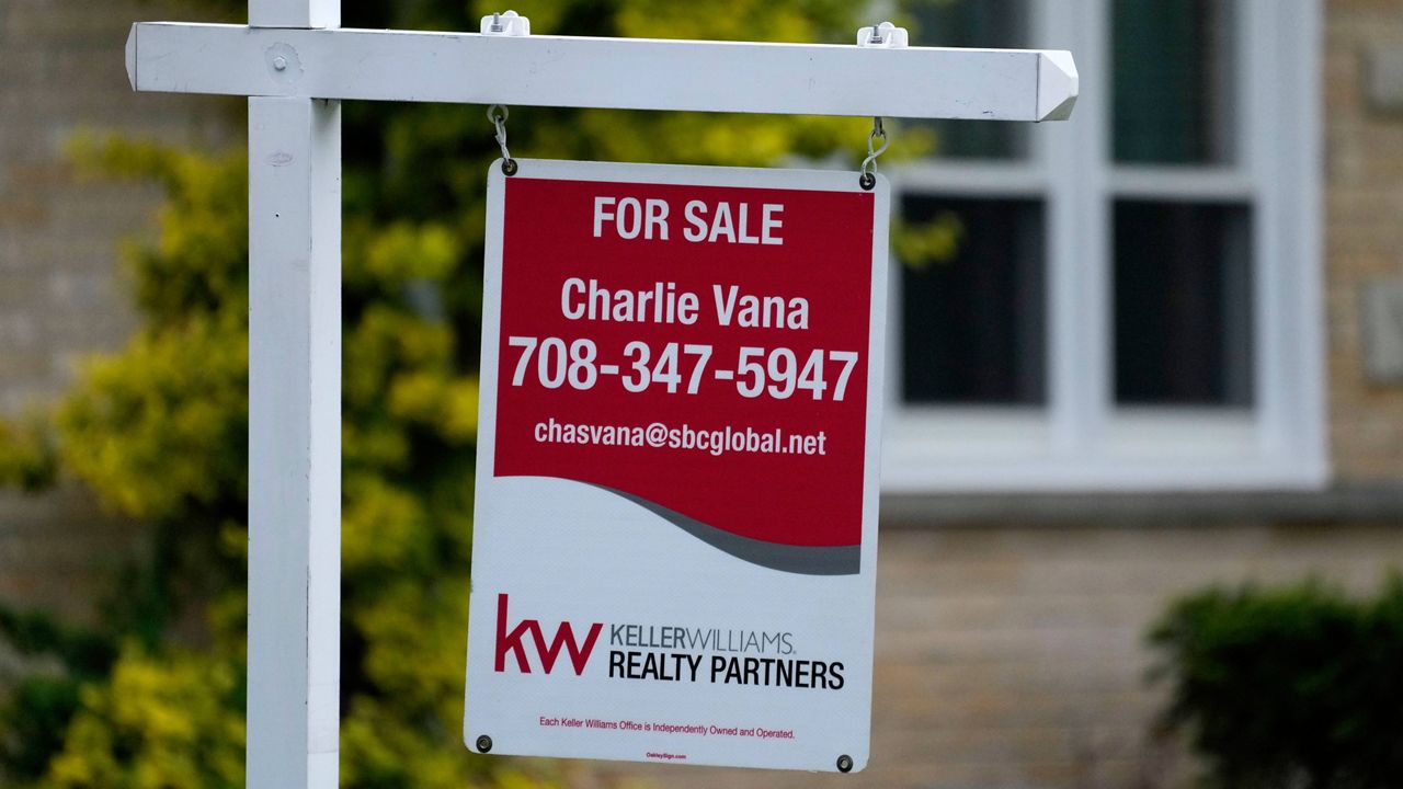 A for sale sign is displayed in front of a home in Wheeling, Ill., on May 2, 2024.