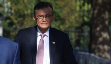 Lip-Bu Tan, chief executive of Intel Corp, walks outdoors in a suit and tie following a White House meeting