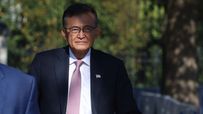 Lip-Bu Tan, chief executive of Intel Corp, walks outdoors in a suit and tie following a White House meeting
