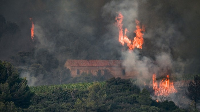 Flames billow from a forest fire near Saint Laurent de la Cabrerisse in Aude, France