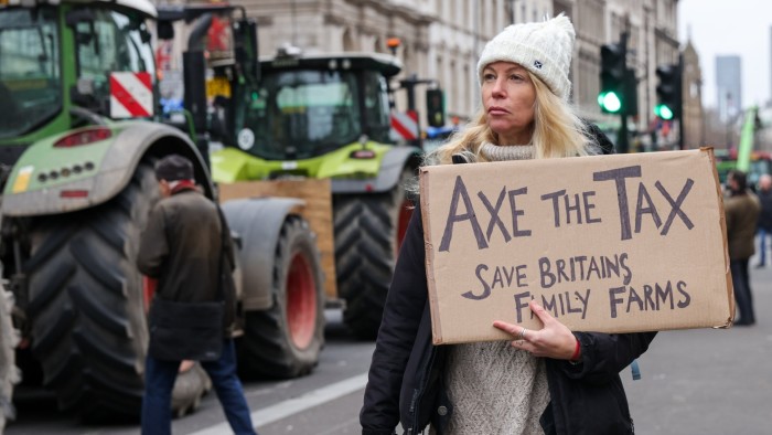 A protester holds a placard on Whitehall, Westminster in central London during the farmers protest in December 2024