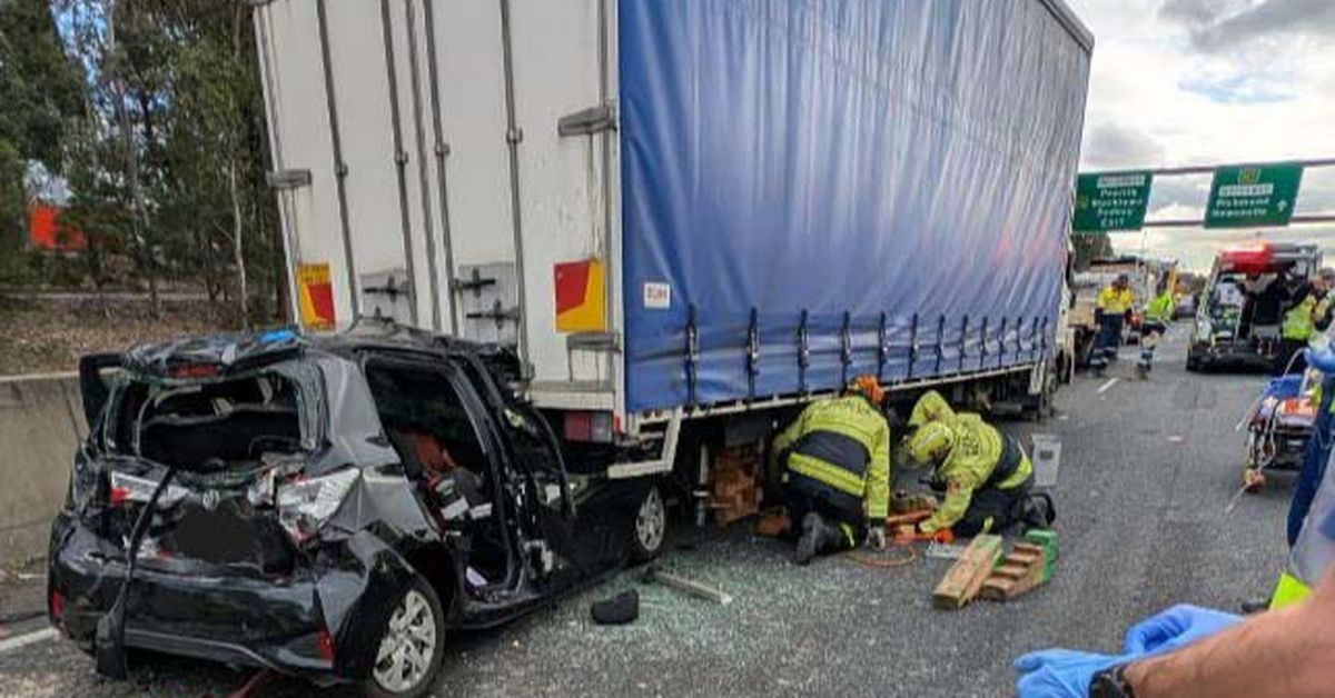 Woman trapped in car between two trucks after horror Sydney crash