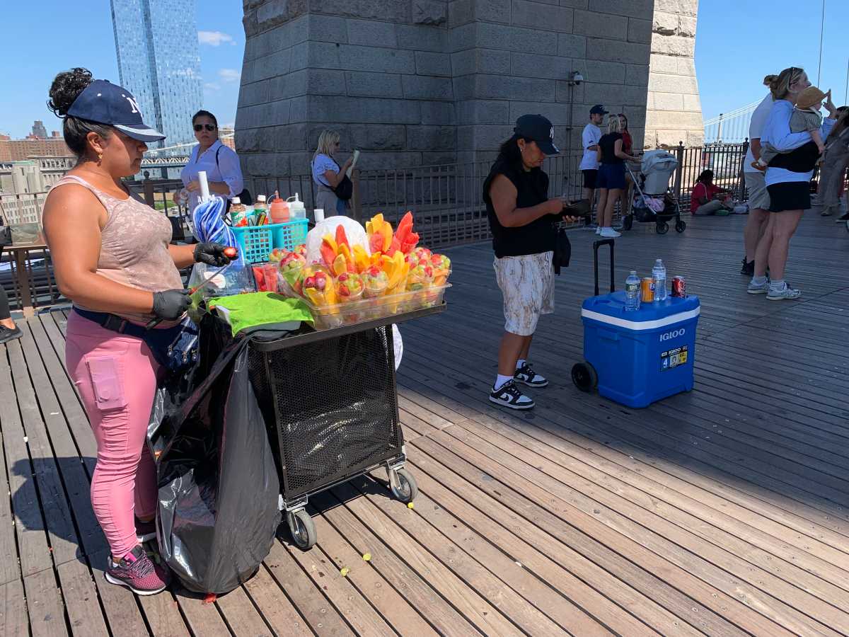 Defying a NYC ban, illegal vending thrives on iconic Brooklyn Bridge this summer