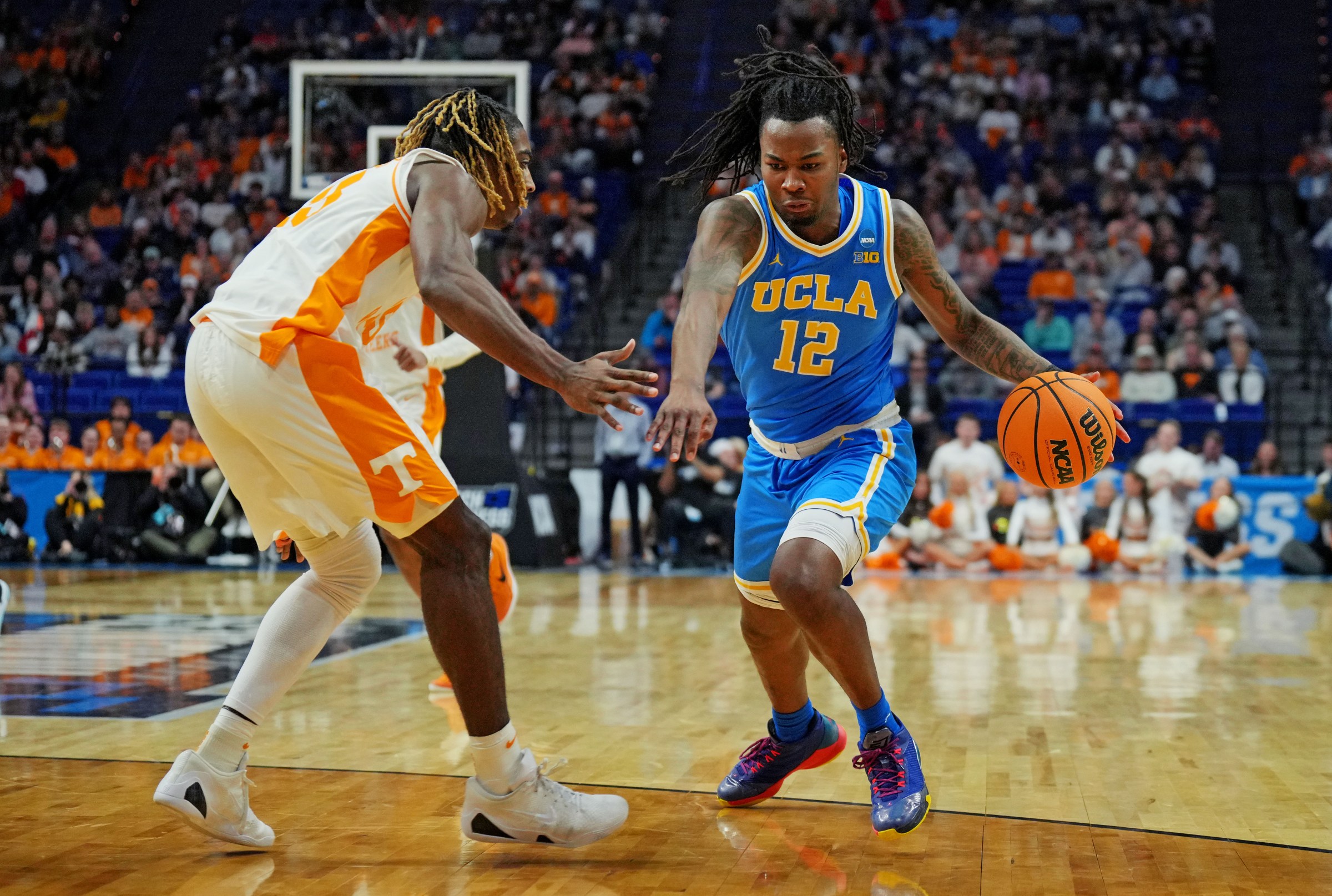 Mar 22, 2025; Lexington, KY, USA; UCLA Bruins guard Sebastian Mack (12) drives to the basket against Tennessee Volunteers forward Felix Okpara (34) during the second half in the second round of the NCAA Tournament at Rupp Arena. Mandatory Credit: Aaron Doster-Imagn Images