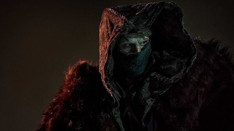 Jacob Elordi as the Monster in hood and mask in Guillermo del Toro's Frankenstein