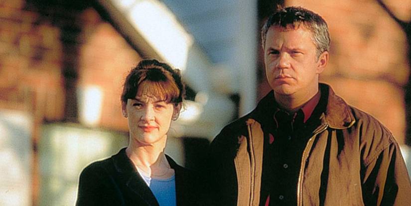 Joan Cusack and Tim Robbins stand next to each other outside and look intimidating in Arlington Road.
