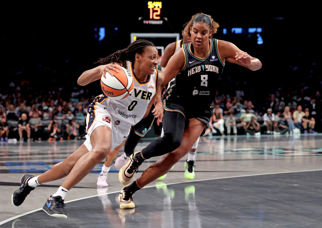 Kelsey Mitchell of the Indiana Fever dribbling the basketball as Nyara Sabally of the New York Liberty defends.