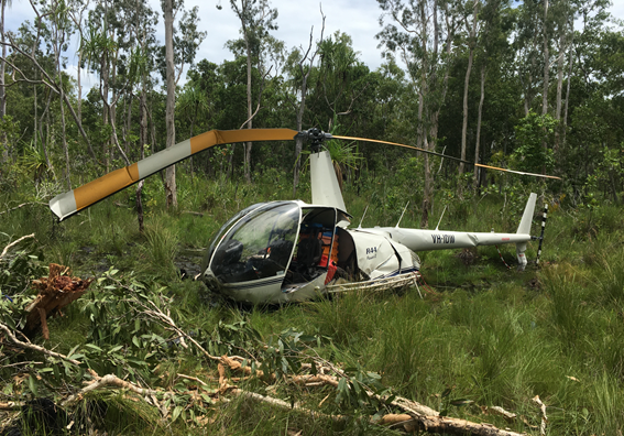 A pictured of a helicopter crashed in grassland.