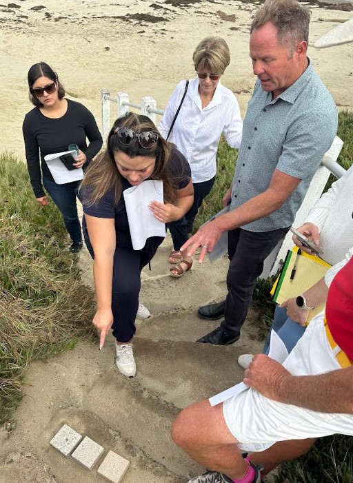 Mayra Medel, Suzanne Segur, Seonaid McArthur and Jim Neri examine concrete samples during a visit to the Whale View Point stairs. (Bob Evans)