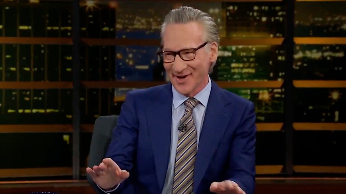 Bill Maher with hands up smiling