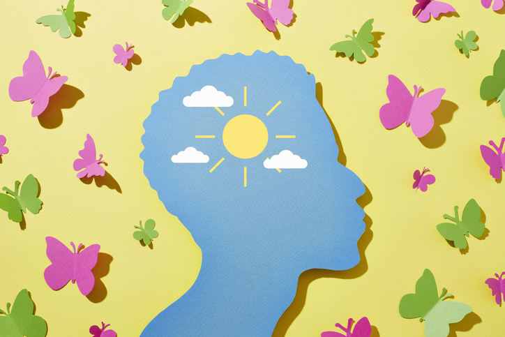 A man surrounded with butterflies and sunshine in his mind