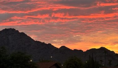 Clouds glow as the sun rises over the Piestewa Peak area in Phoenix, Arizona, after a night of mons...