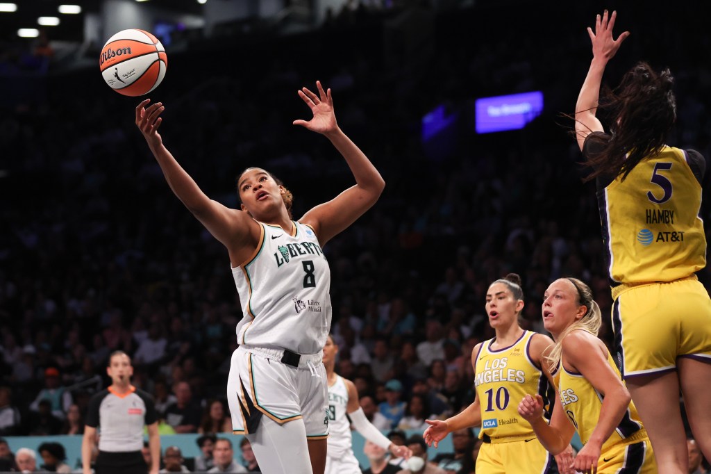 New York Liberty player Nyara Sabally (#8) shoots a basketball during a game against the Los Angeles Sparks.