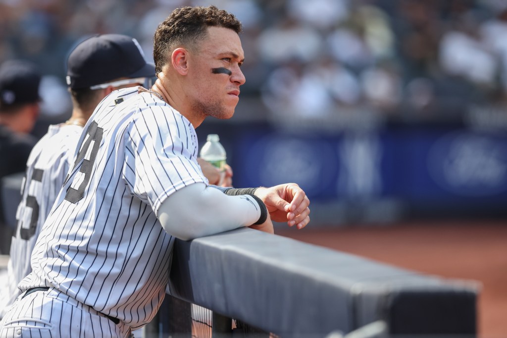 New York Yankees designated hitter Aaron Judge (99) watches from the dugout in the ninth inning against the Houston Astros at Yankee Stadium. 