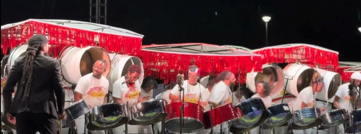 Pan Evolution Steel Orchestra of New York on stage with arranger André White (left) for Panorama 2025