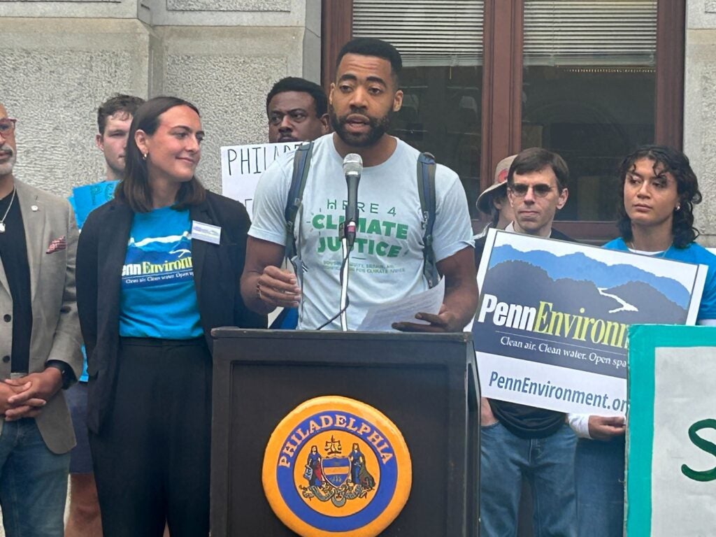 Patrick Houston speaking at a podium during the rally