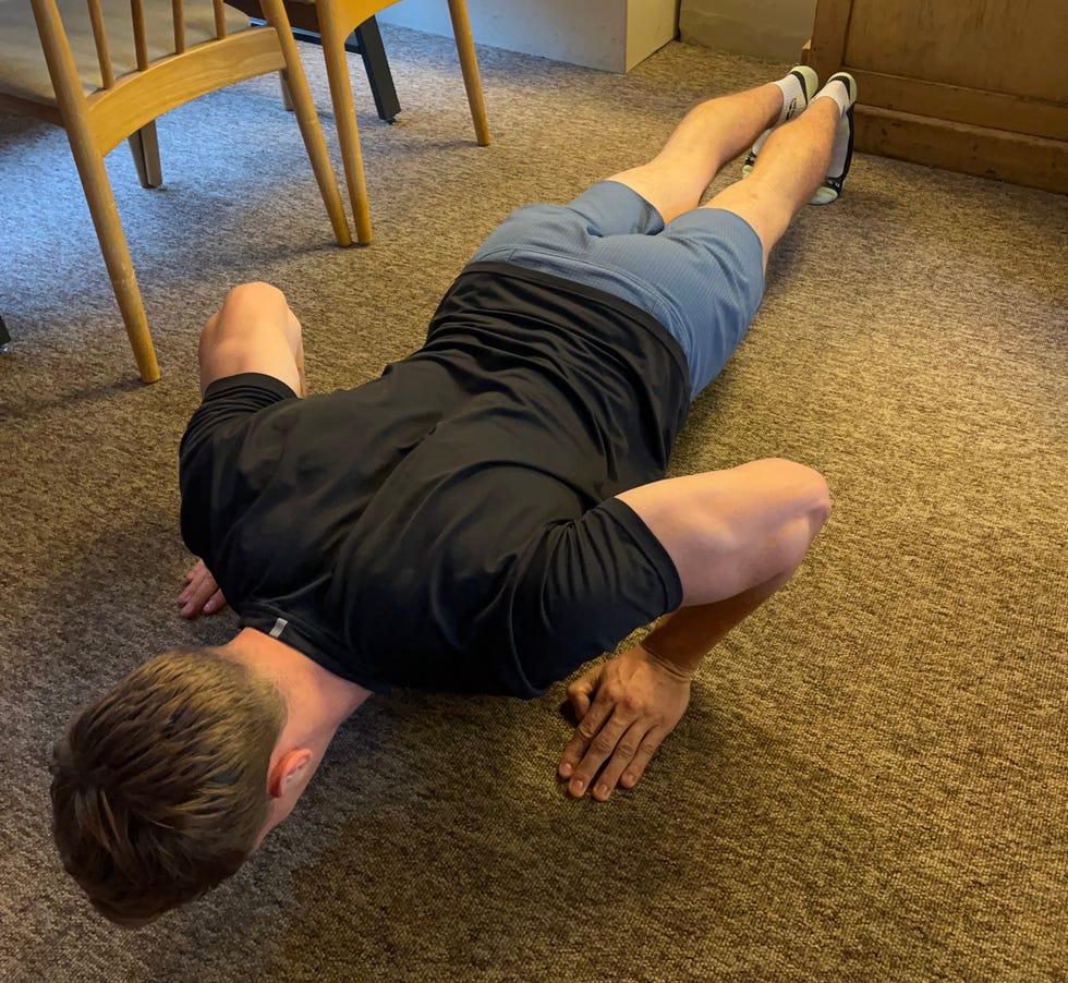 demonstration of a person performing a pushup exercise indoors