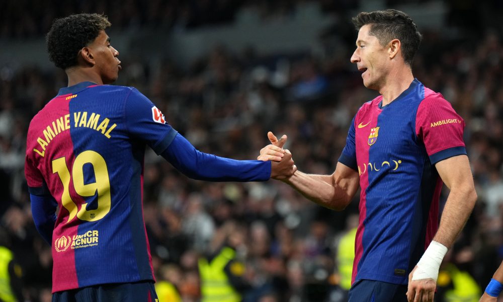 MADRID, SPAIN - OCTOBER 26: Robert Lewandowski of FC Barcelona celebrates scoring his team's second goal with teammate Lamine Yamal during the LaLiga match between Real Madrid CF and FC Barcelona at Estadio Santiago Bernabeu on October 26, 2024 in Madrid, Spain. (Photo by Angel Martinez/Getty Images)