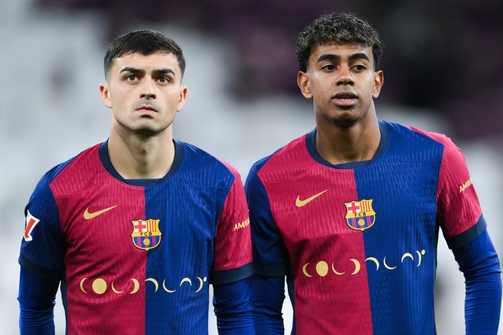 MADRID, SPAIN - OCTOBER 26: Pedri and Lamine Yamal of FC Barcelona wear a special edition Coldplay match shirt during the LaLiga match between Real Madrid CF and FC Barcelona at Estadio Santiago Bernabeu on October 26, 2024 in Madrid, Spain. (Photo by David Ramos/Getty Images)