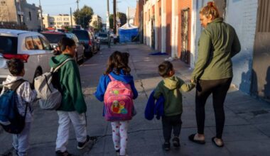 Nubia Reyes walks with her son and other migrant children to school on Skid Row in Los Angeles. (Los Angeles Times/Brian van der Brug)