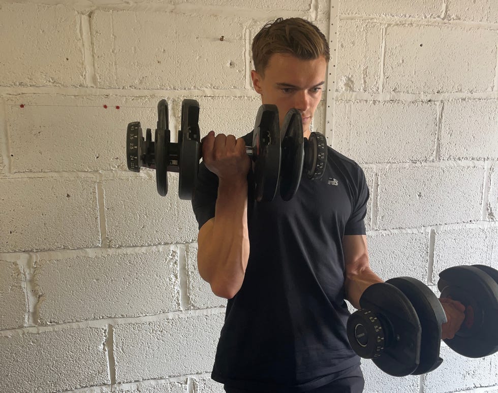 a person exercising with dumbbells in a gym environment