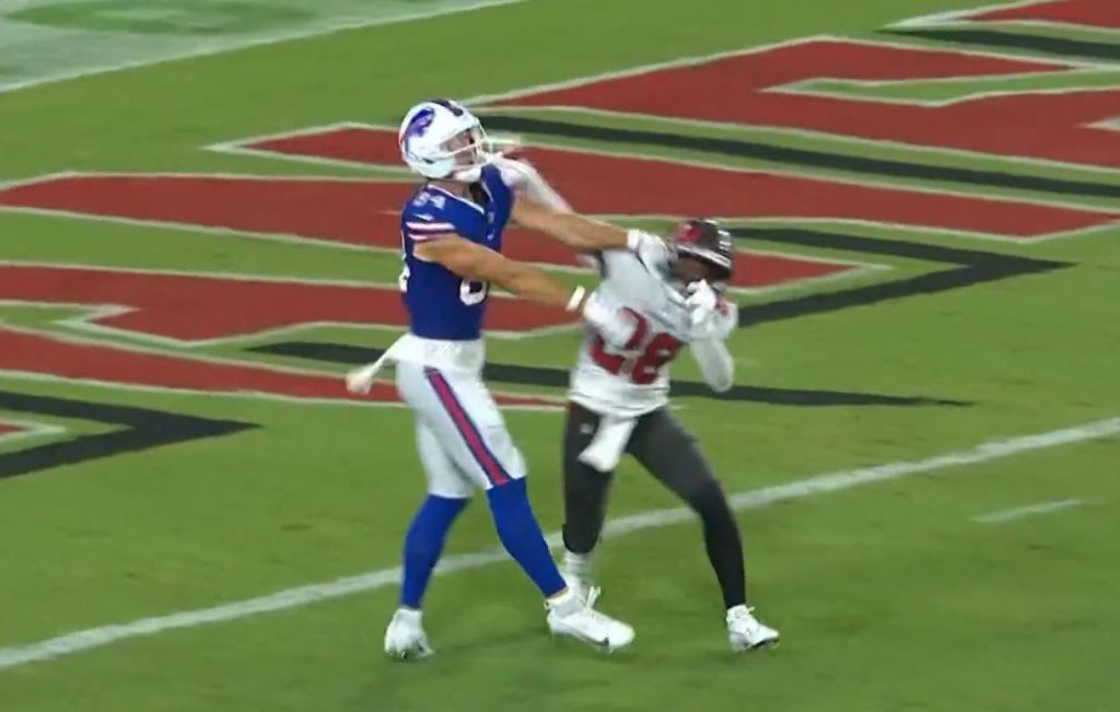 Football players making a tackle.