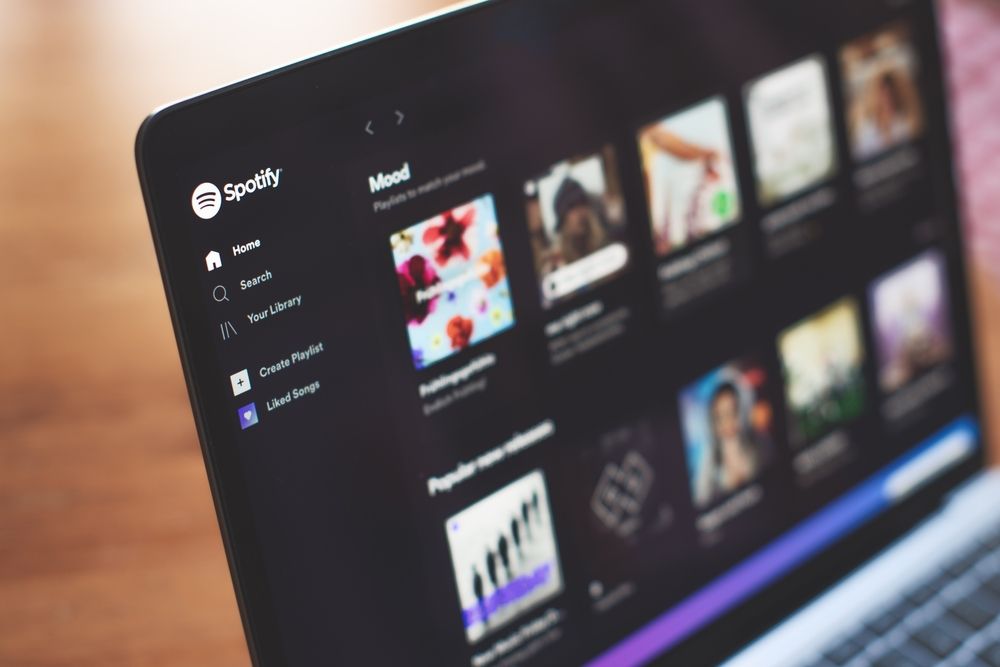 A laptop screen with Spotify displayed.