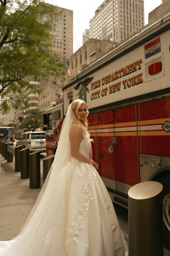 Kirstin Marino in wedding dress next to a New York City firetruck.
