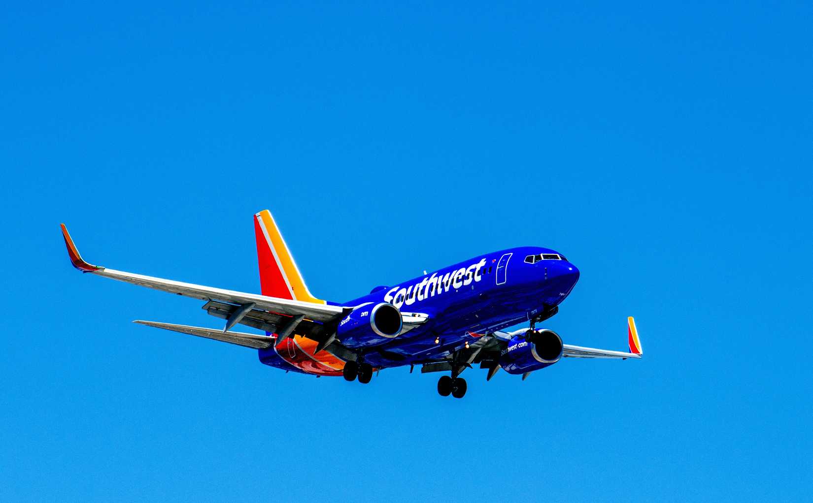 Southwest Airlines, Boeing 737-7H4, B737, narrow body aircraft landing, landing gear and flaps down. Passenger connection flight commuter service